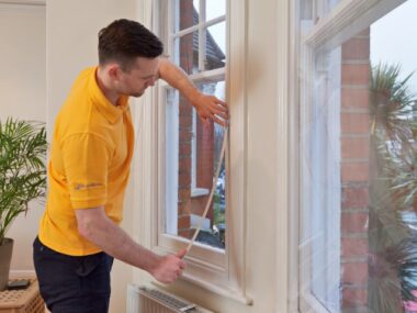 An image showing a WindowSkin fitter installing magnetic secondary glazing to a traditional timber sash window