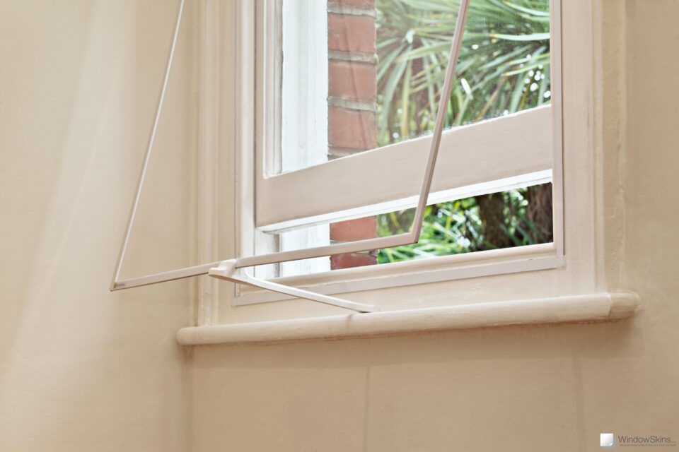 An opened sash window and WindowSkin propped open with venting arm