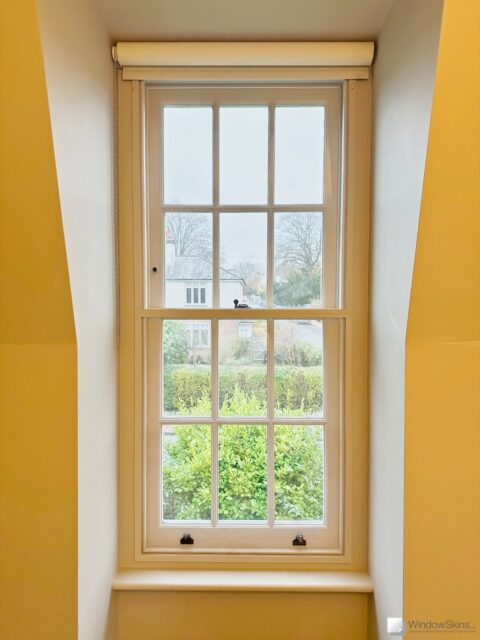 colour matched magnetic secondary glazing (WindowSkin) fitted to a white sash window in the outer placement, with a split panel.