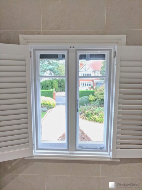 Pair of casement windows fitted with WindowSkins magnetic secondary glazing and plantation style shutters