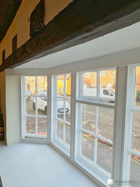 Street facing cottage windows with WindowSkins magnetic secondary glazing fitted for noise reduction and warmth