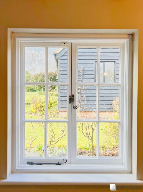 Double casement window fitted with Perspex magnetic secondary glazing