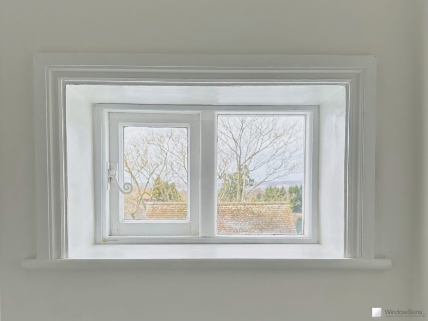 Small cottage window fitted with a single WindowSkins magnetic secondary glazing panel