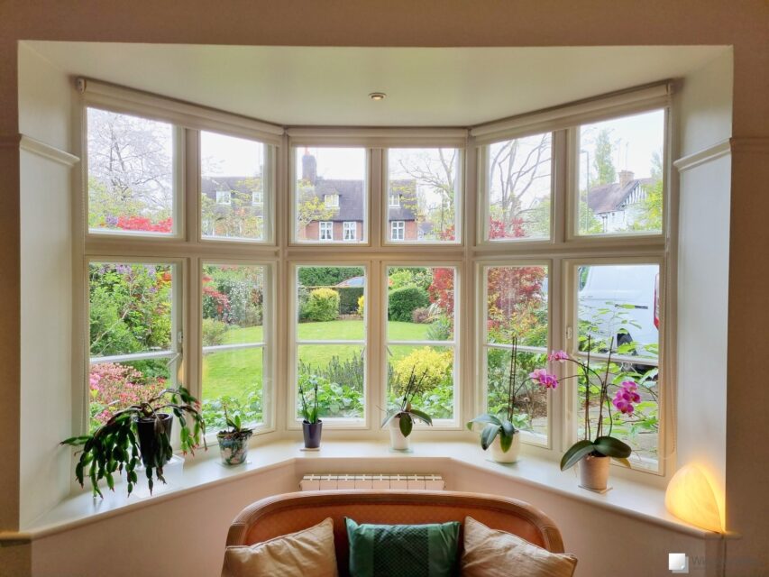 Wide view of colour matched WindowSkins magnetic secondary glazing set against a beige coloured timber casement window bay