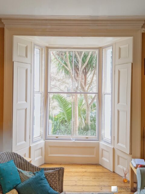WindowSkins magnetic secondary glazing fitted to three sash windows with period Georgian panel shutters