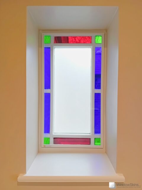 Small stained glass window fitted with WindowSkins magnetic secondary glazing