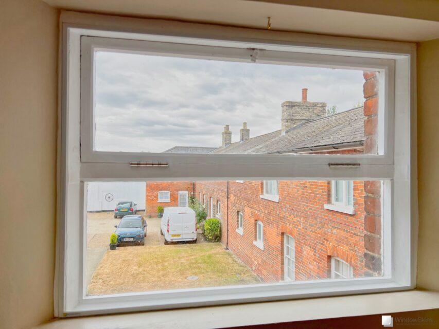 Cottage timber casement window with upper hinged fanlight fitted with WindowSkins magnetic secondary glazing. Reduces cold, draught, condensation and noise.