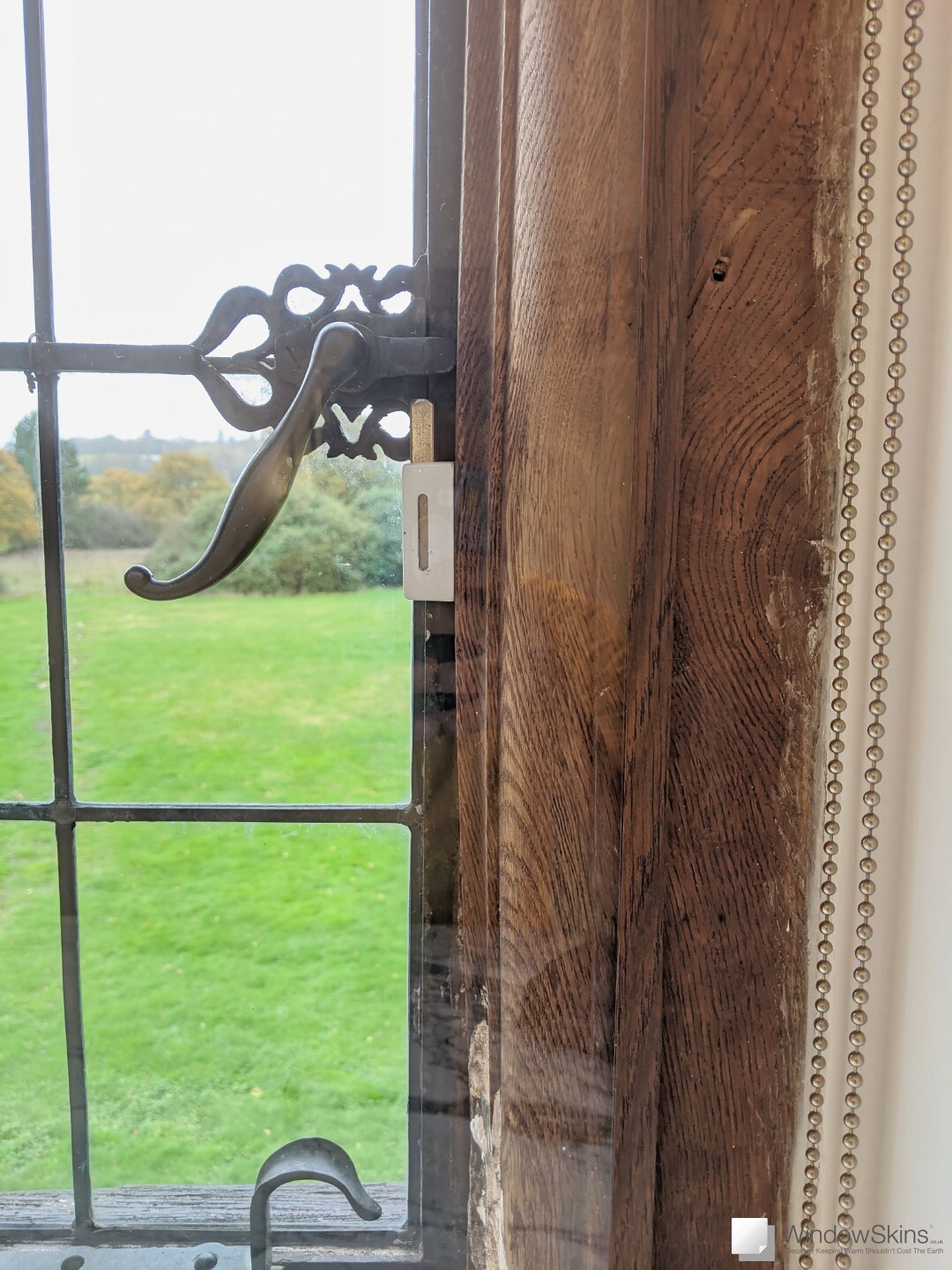 Close up of listed timber casement window with wood grain colour matched magnetic secondary glazing