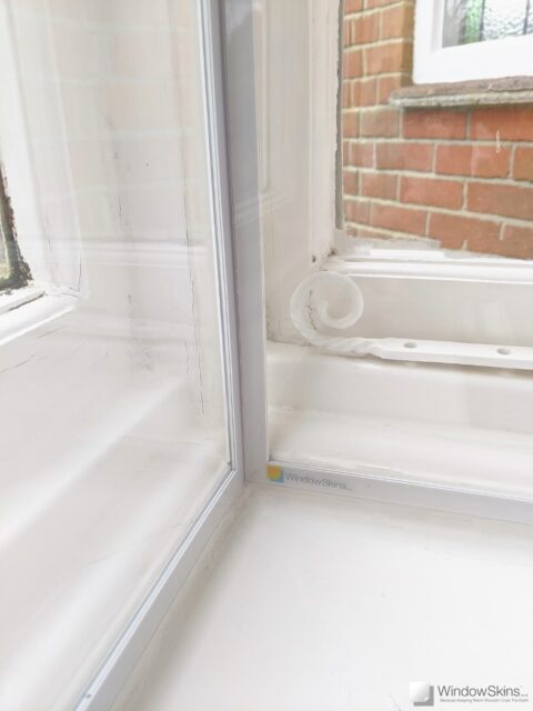 Closeup of a two Perspex glazing panels set in a corner arrangement using a floating magnetic connector