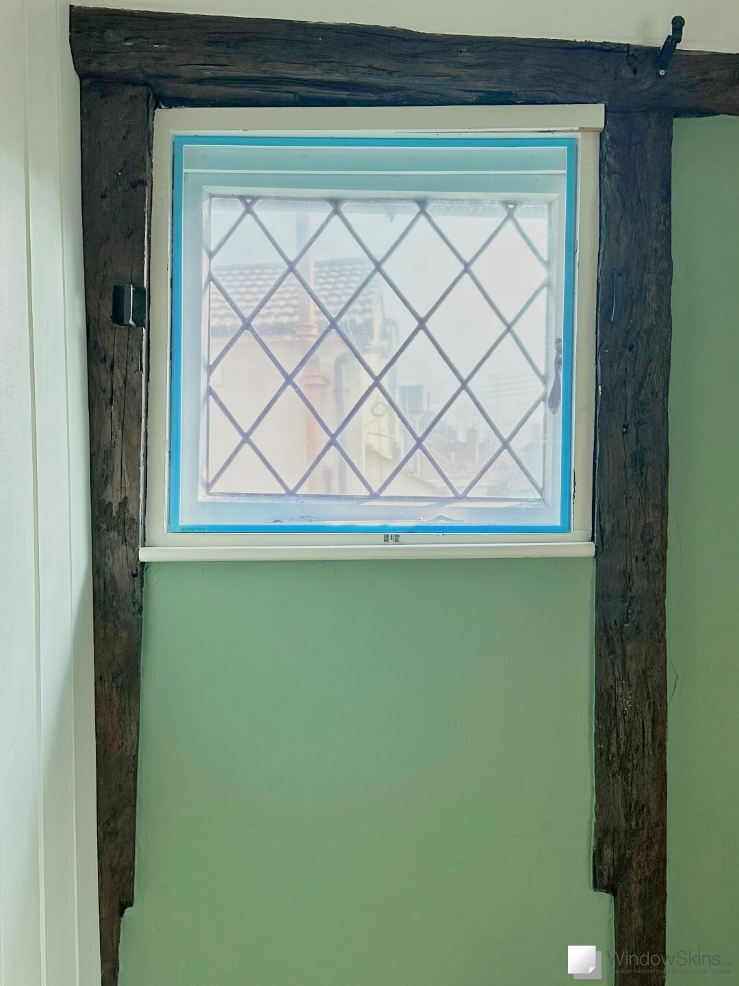 A wonky wooden casement window fitted with an accurately measured WindowSkin