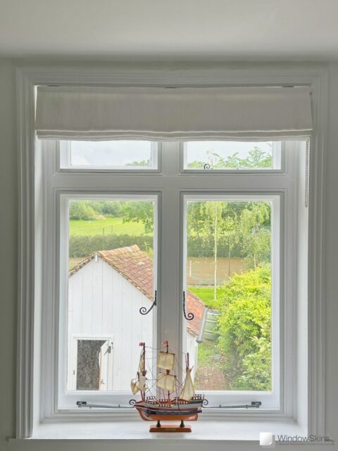 Wooden window fitted with four WindowSkin secondary glazing panels to lower casement and upper fanlights