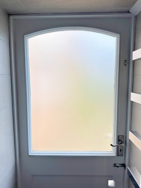 Frosted bathroom door fitted with colour matched WindowSkins magnetic secondary glazing panel