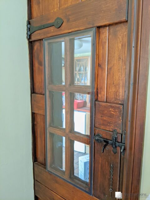 Pantry door retrofit with dark brown secondary glazing panel