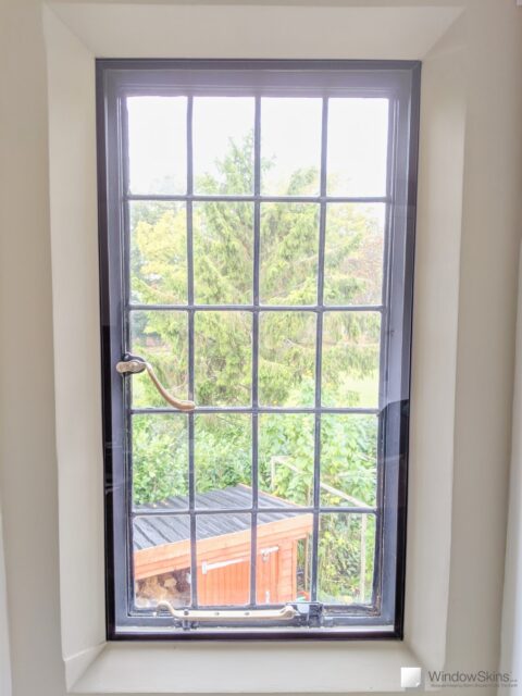 Steel window with leaded lights set in stone mullion and fitted with secondary double glazing using a bespoke subframe