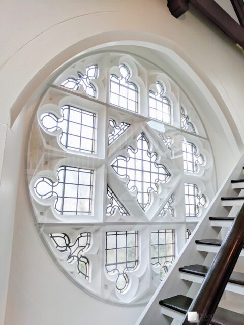 Large circular stone mullion church gable window fitted with three bespoke WindowSkins secondary glazing panels in the outer placement
