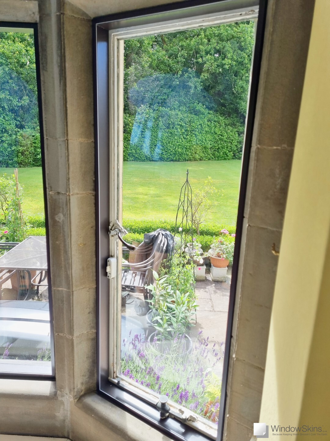 Listed property stone mullion window fitted with bespoke painted timber frames and WindowSkins magnetic secondary glazing