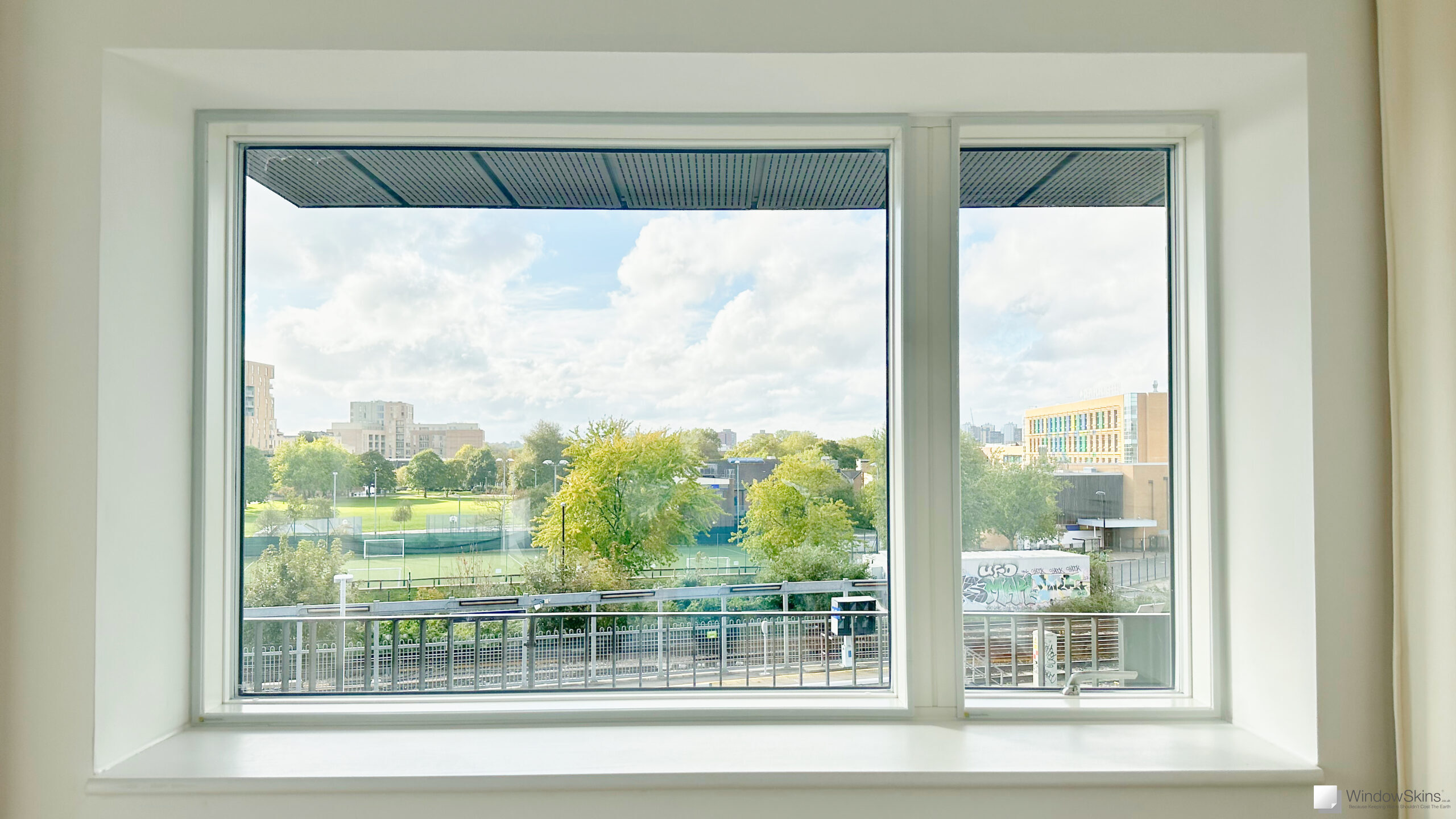 Magnetic secondary double glazing installed on a new-build uPVC window near railway line for noise reduction and sound insulation