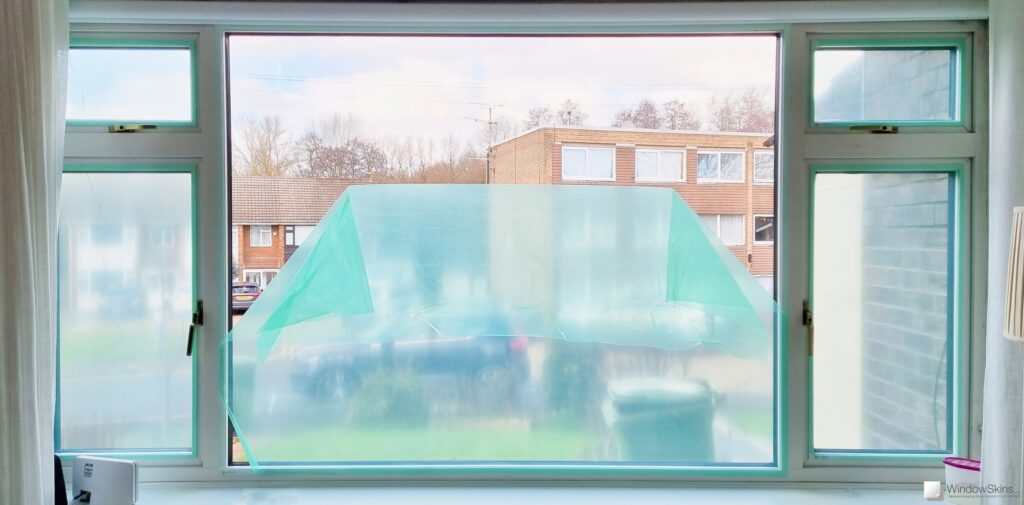 Magnetic triple glazing panels retrofit on a large uPVC double glazed picture window to reduce heat loss and improve insulation