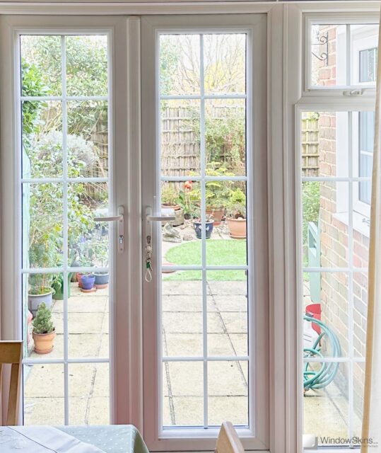 Magnetic secondary glazing installed on French uPVC patio doors to improve insulation and reduce heat loss