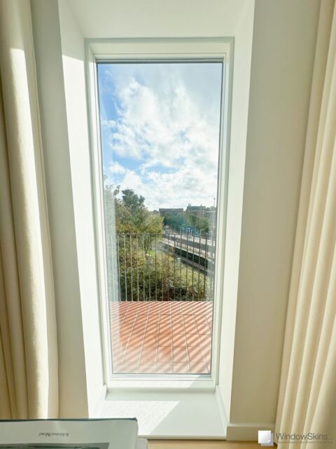 Magnetic secondary glazing installed on a uPVC window near railway line for noise reduction and acoustic insulation