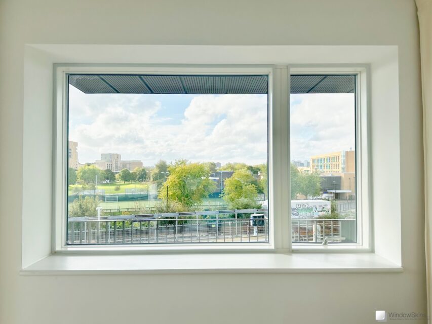 Magnetic secondary double glazing installed on a new-build uPVC window near railway line for noise reduction and sound insulation