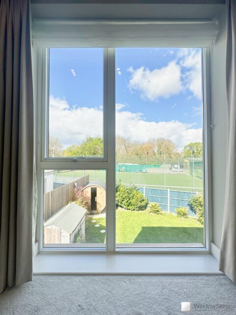 Magnetic secondary glazing panels installed to new-build uPVC bedroom windows improving insulation and noise reduction.