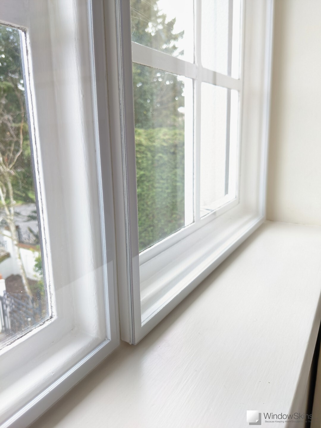 Magnetic secondary glazing panel installed behind Crittall style steel window to reduce draughts, cold and condensation