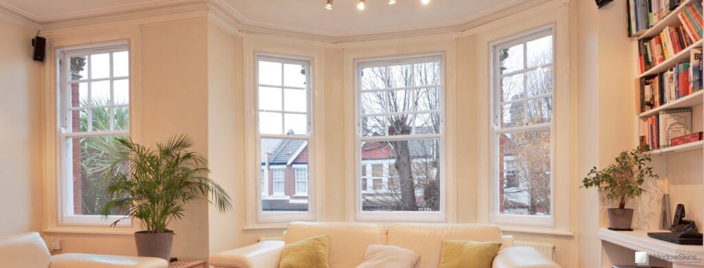Wide view of four sash windows fitted with WindowSkins magnetic secondary glazing in the background